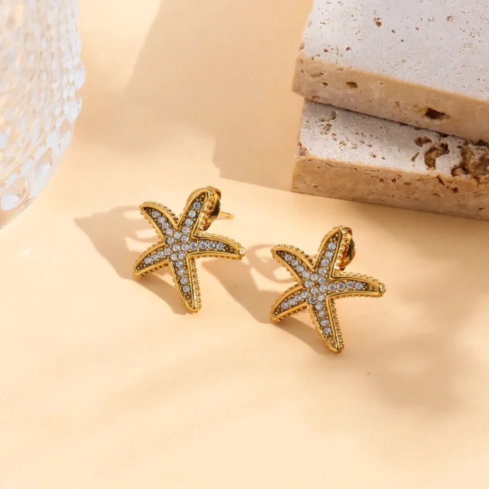 Close-up of material and finish — Starfish stud earrings rhinestone embellished gold