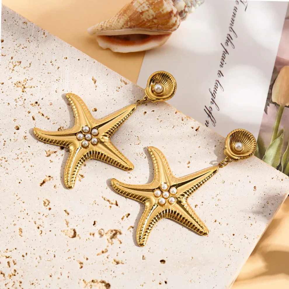 Detalhe do material e do acabamento — Brincos dourados estrela do mar e pérolas elegantes