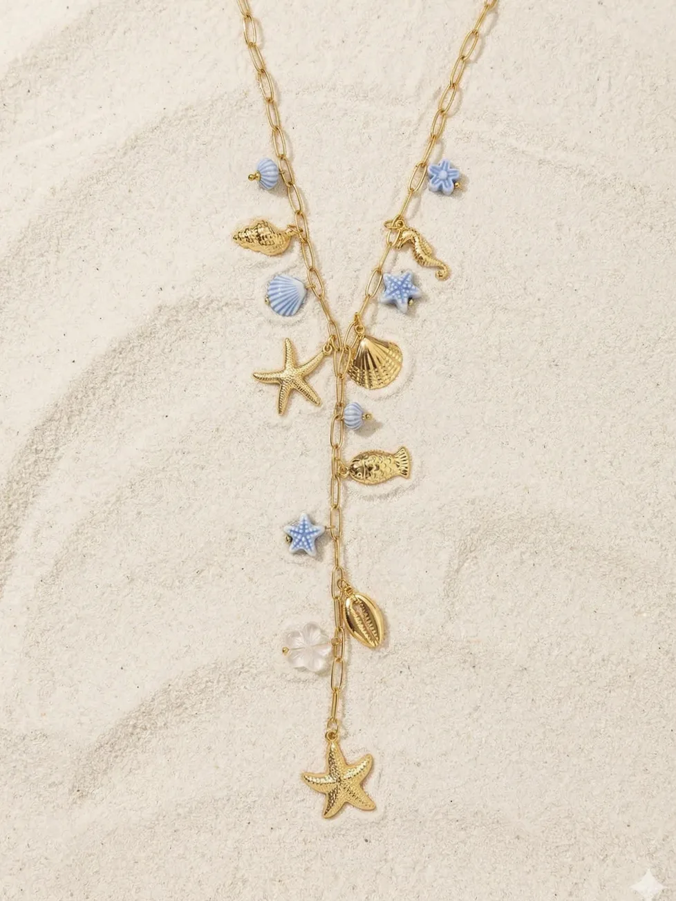 Close-up of material and finish — Gold Y necklace marine charms light blue flowers